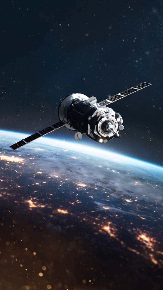 A satellite-bearing cargo spaceship in orbit around the Earth